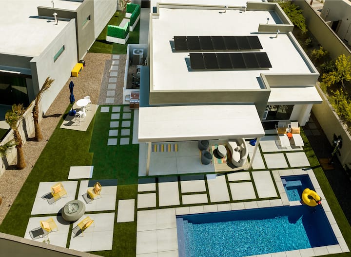 Aerial view of the house and its walled backyard, with the lawn, fire pit, covered patio and pool