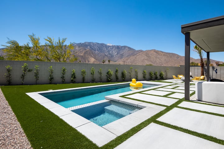 The hot tub at the end of the lap pool, with the mountains rising behind the wall