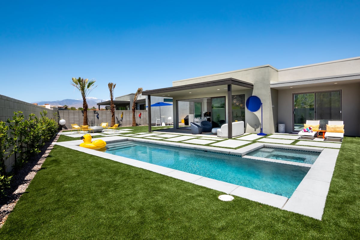 The lap pool, lawn and covered patio behind Posh Place