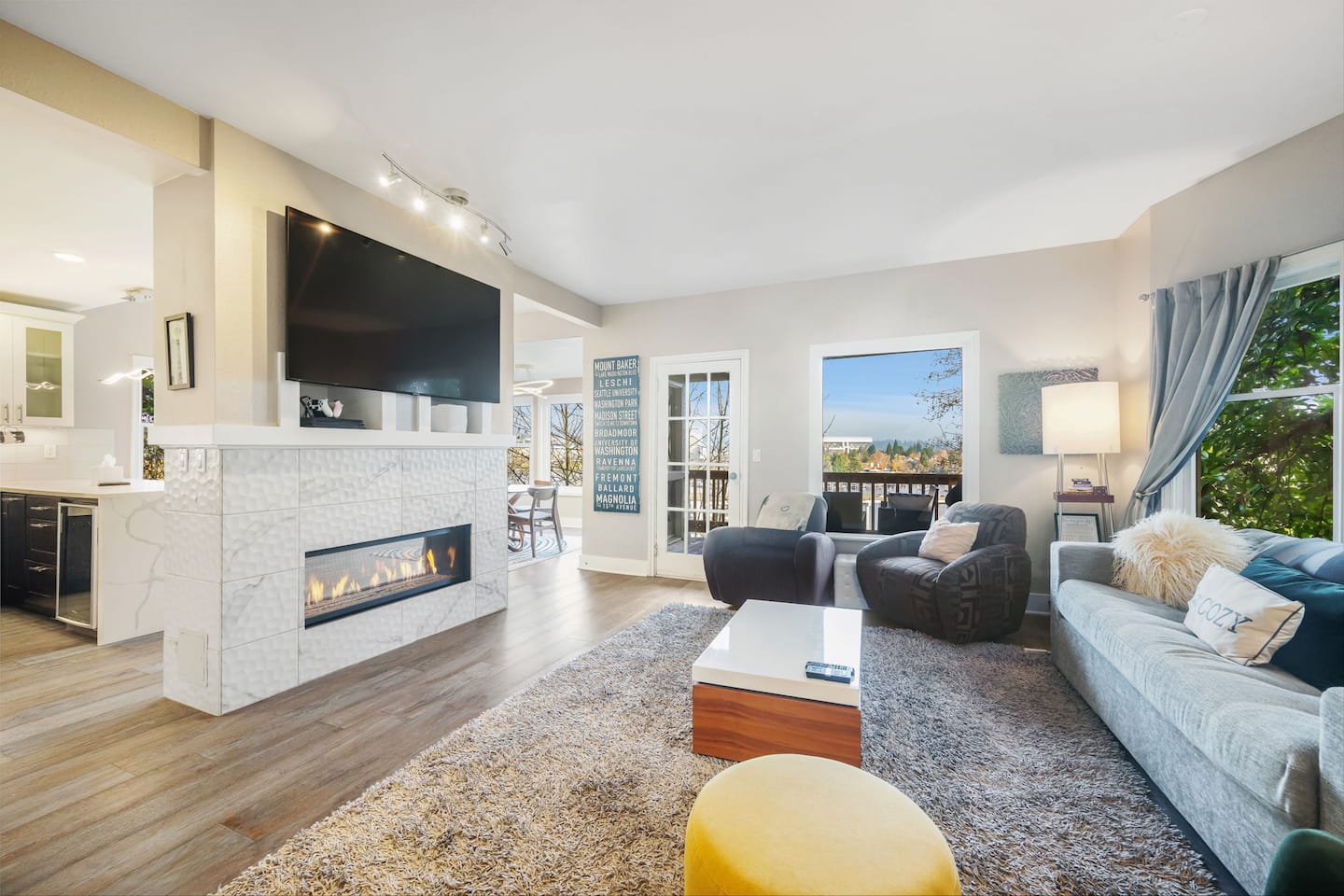 Living room with a see-through gas fireplace and large windows